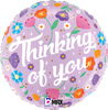 This light purple balloon what the caring message Thinking of You surrounded by bright flowers